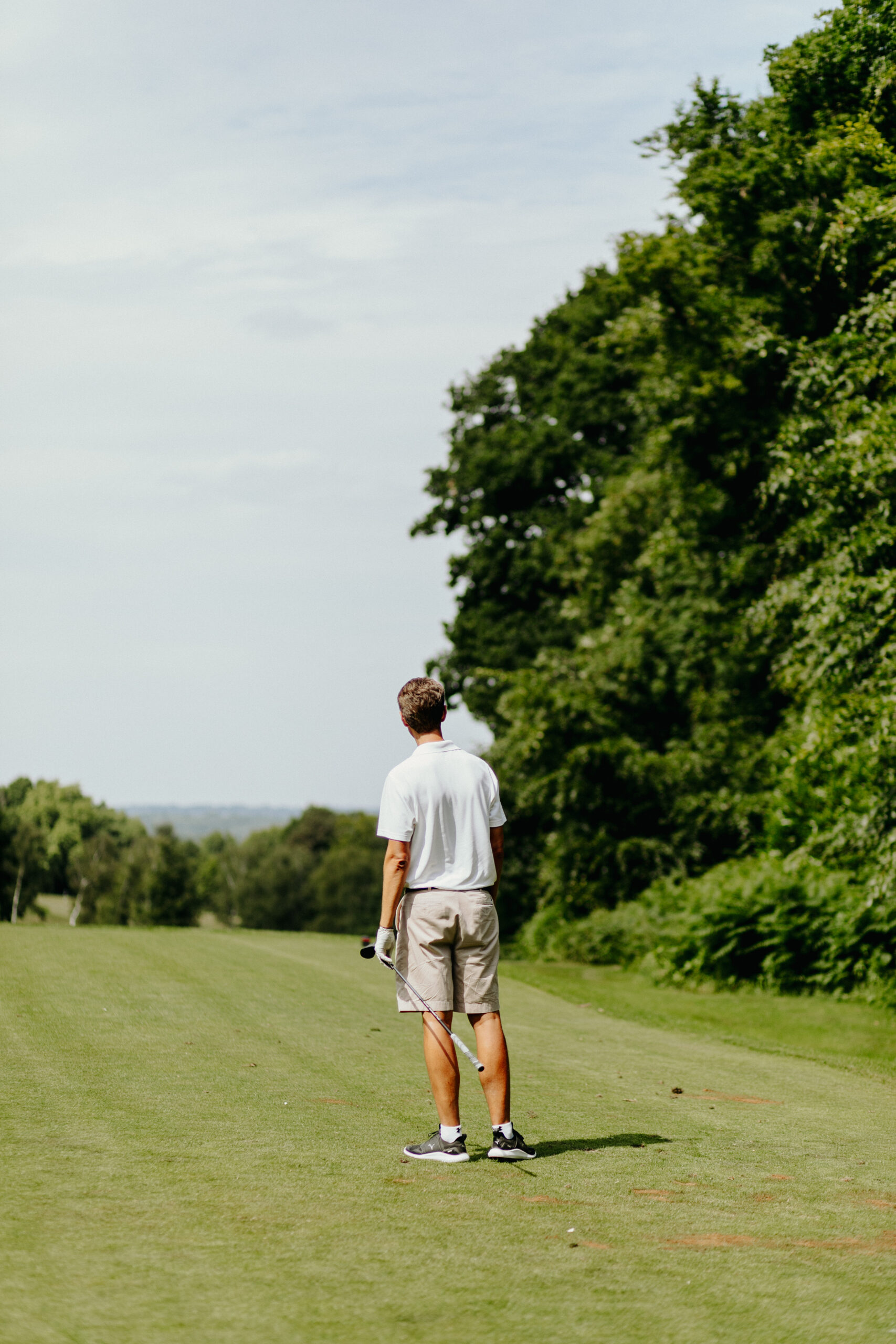 golf_pic17_green_standing A man in white shirt lokking out over the golf green
