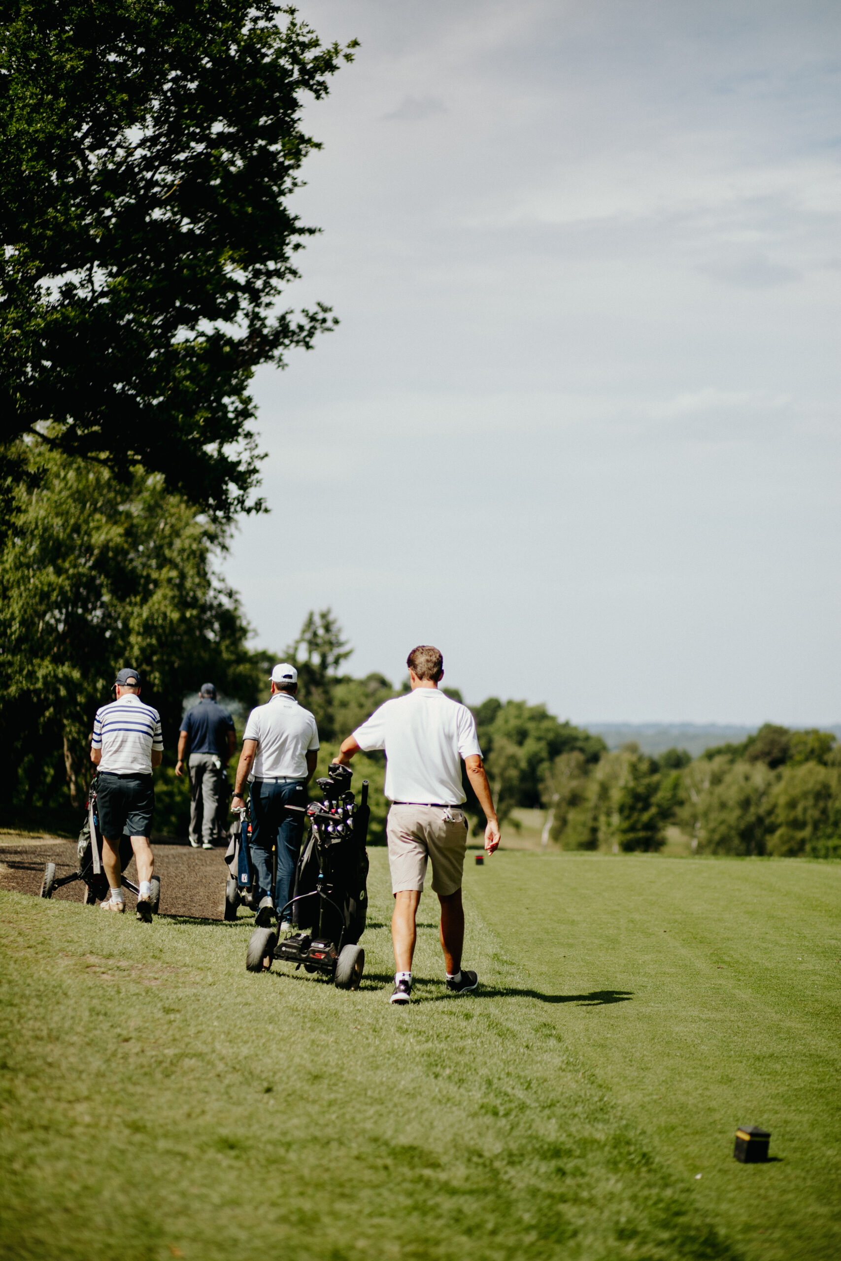 golf_pic19_walkingongreen_standing A group of men walking on the golf green