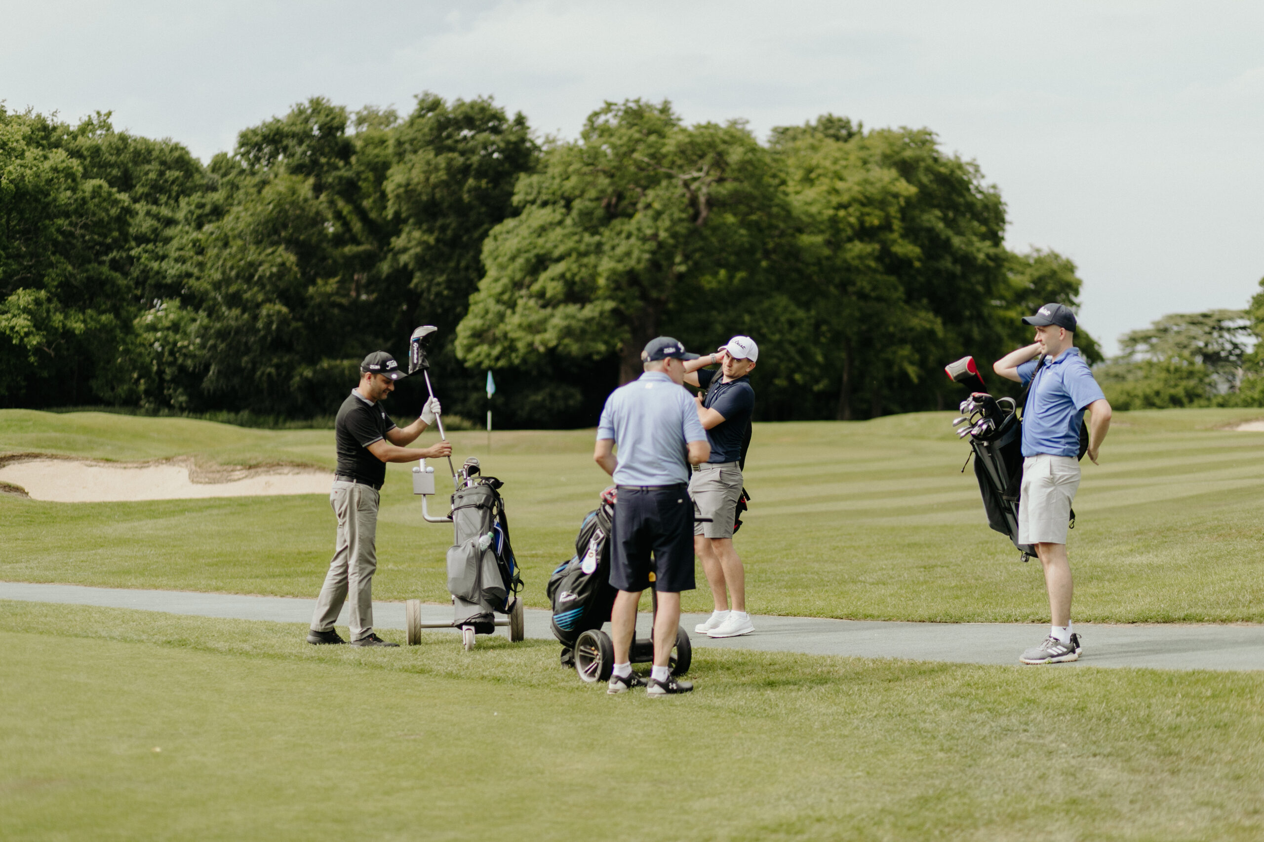 golf_pic27_groupongreen_laying a group of men standing on the green