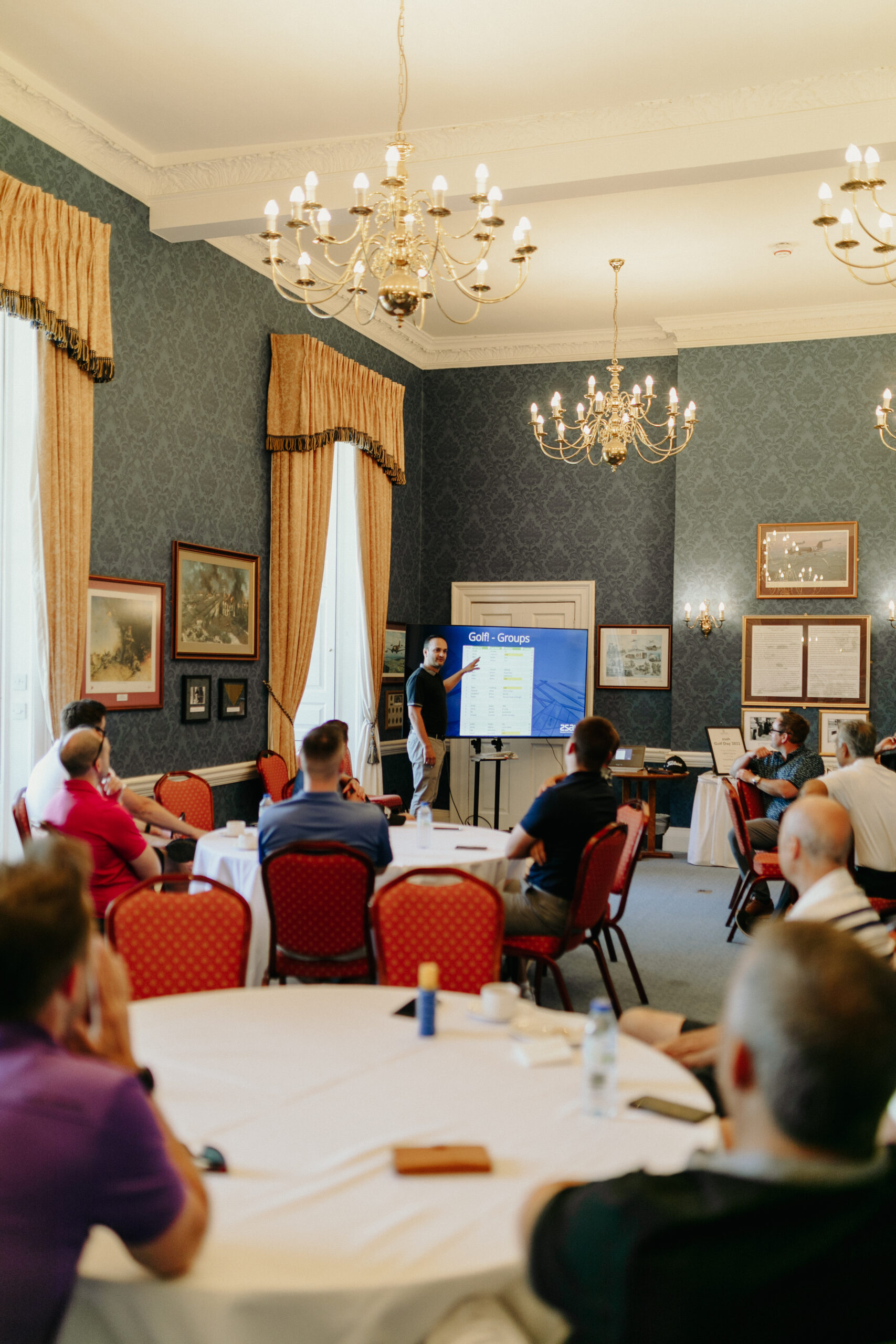 golf_pic9_amirpresentation_standing A man holding a presentation in blue room